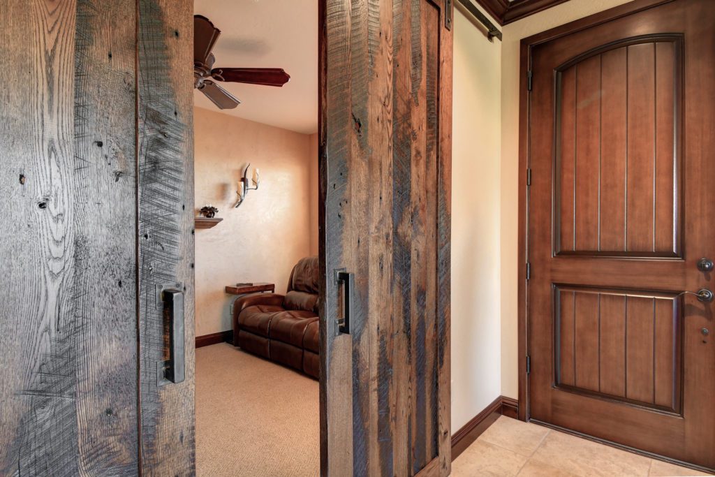 A room with two sliding doors and a couch.
