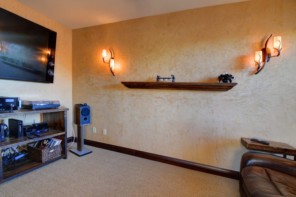 A room with a shelf and a speaker system.