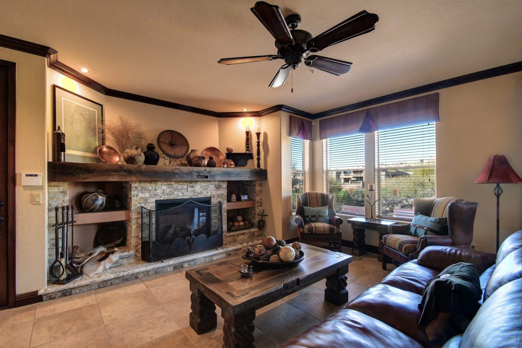 A living room with a fireplace and a large window.