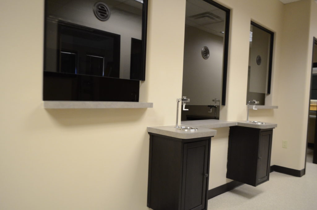A bathroom with two sinks and mirrors in it