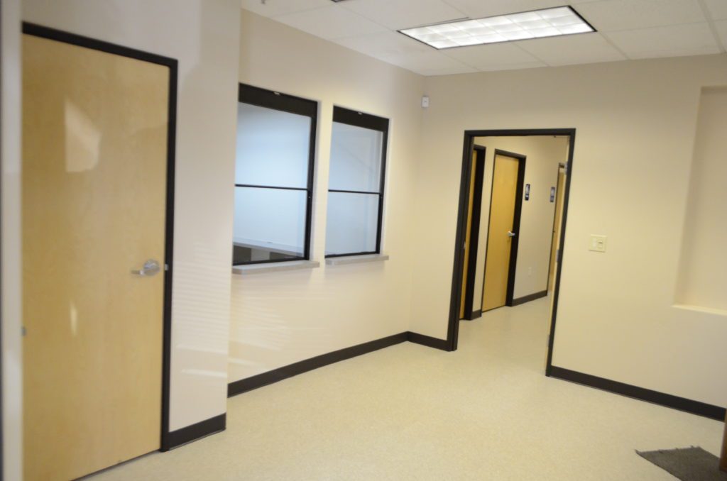 A room with two doors and windows in it
