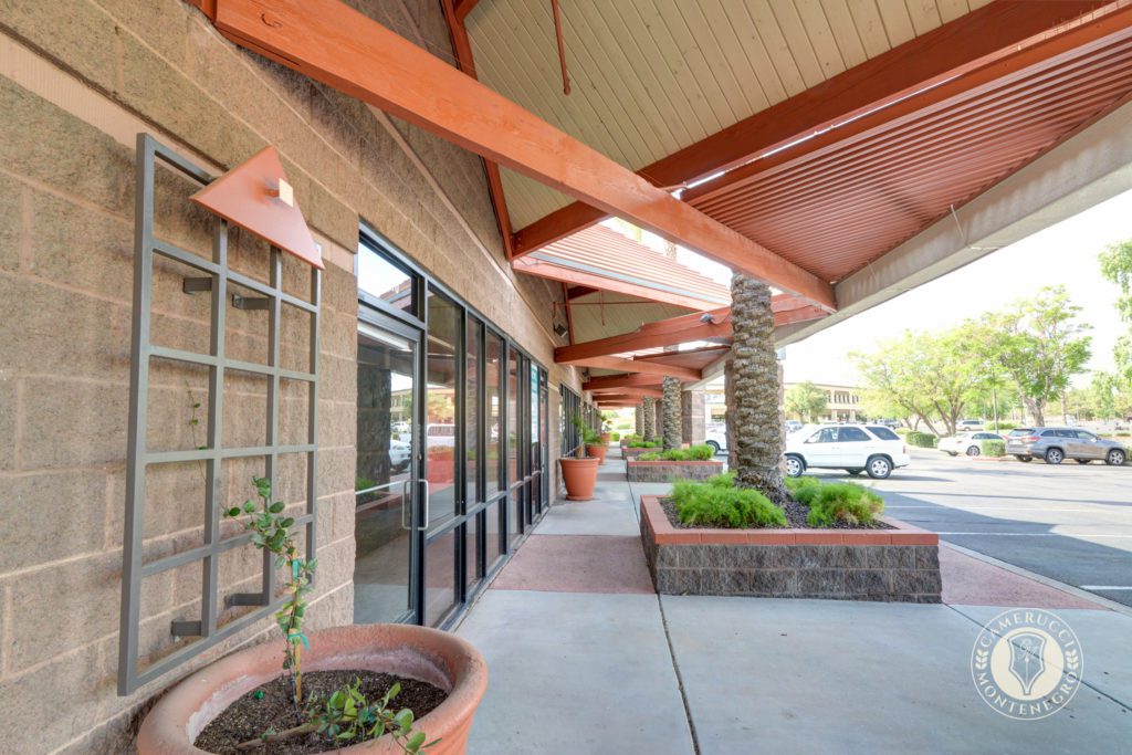 A building with many windows and plants in the center.