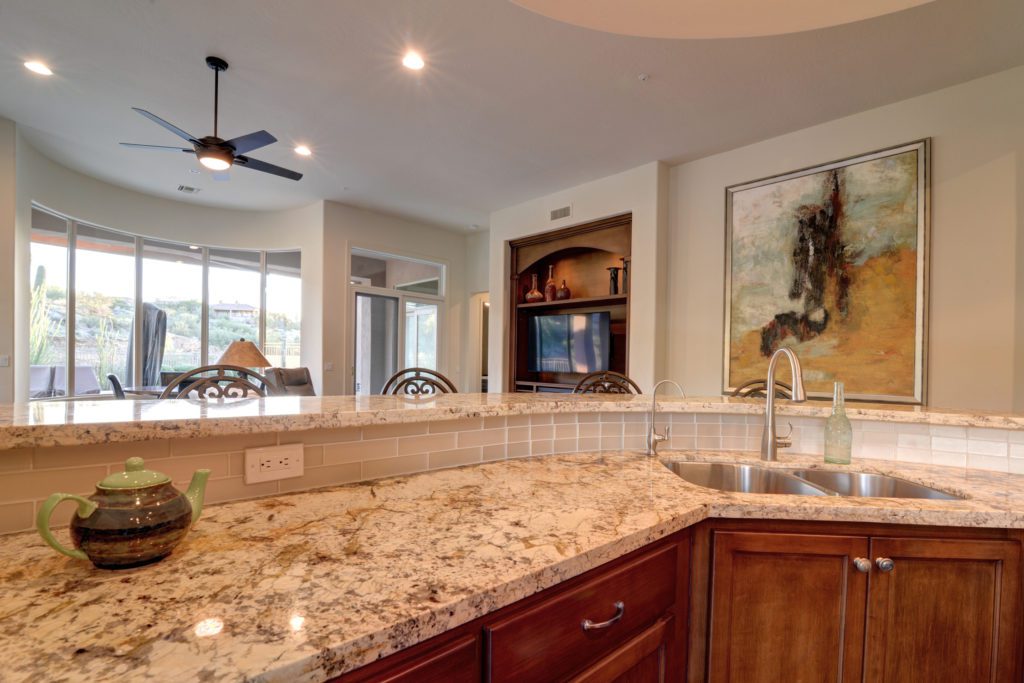 A kitchen with a sink and a mirror