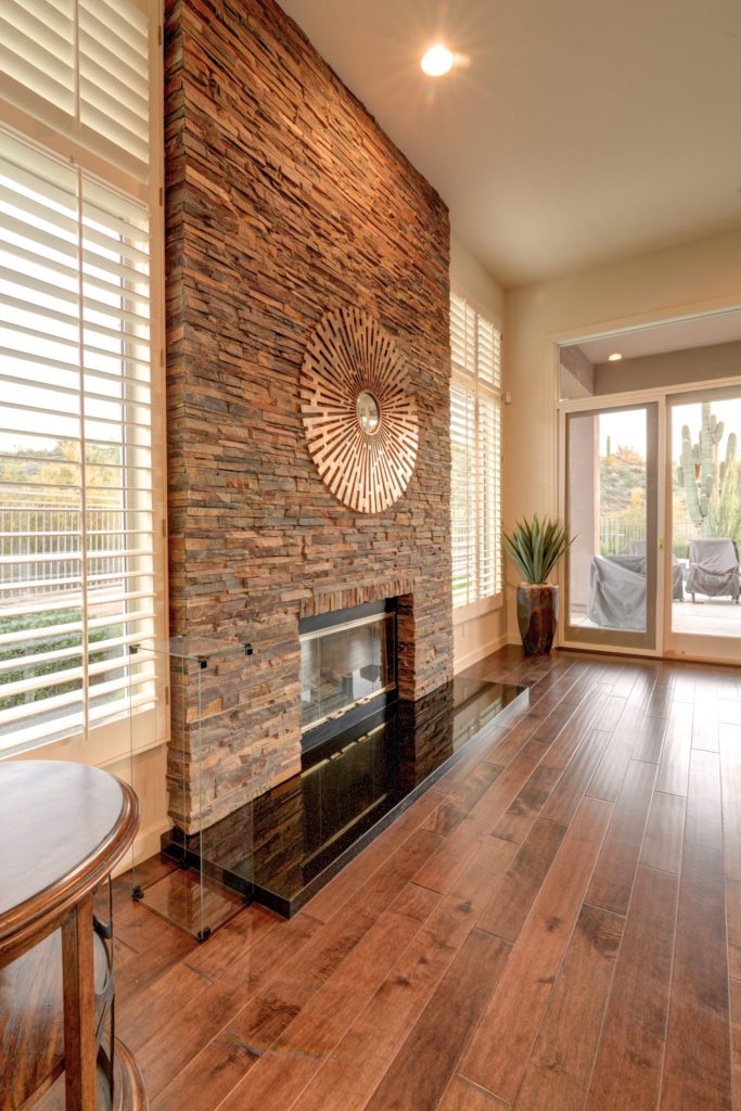 A fireplace in the middle of a living room.
