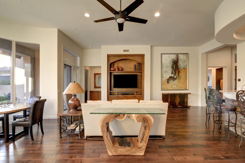A living room with wood floors and white walls.