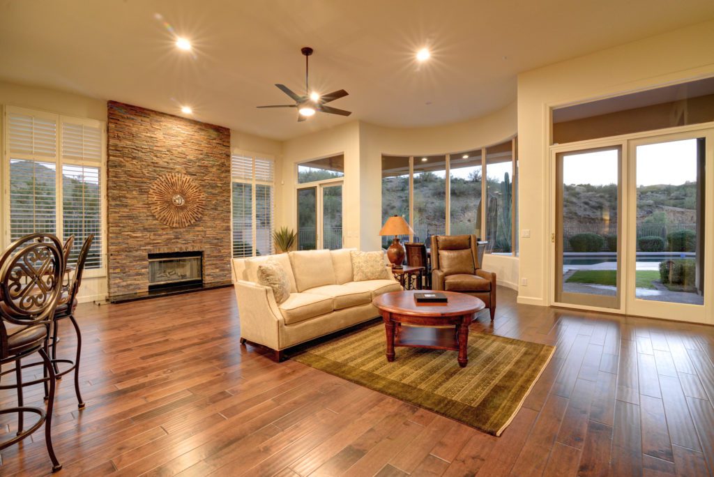 A living room with hard wood floors and furniture.