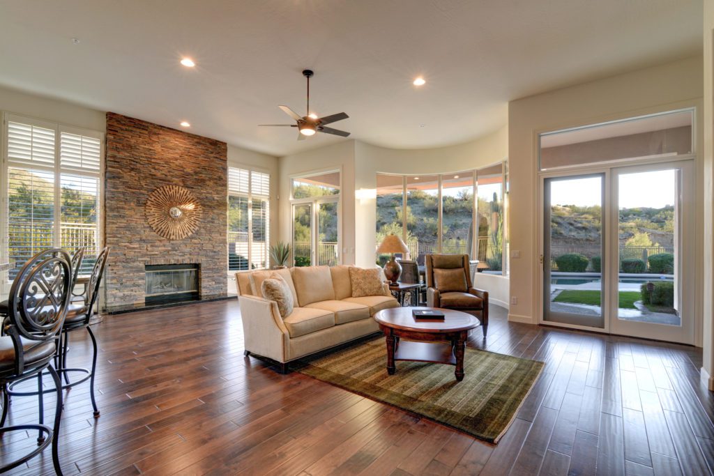 A living room with hard wood floors and furniture.