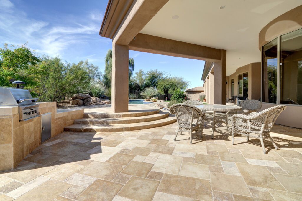 A patio with chairs and tables in the middle of it