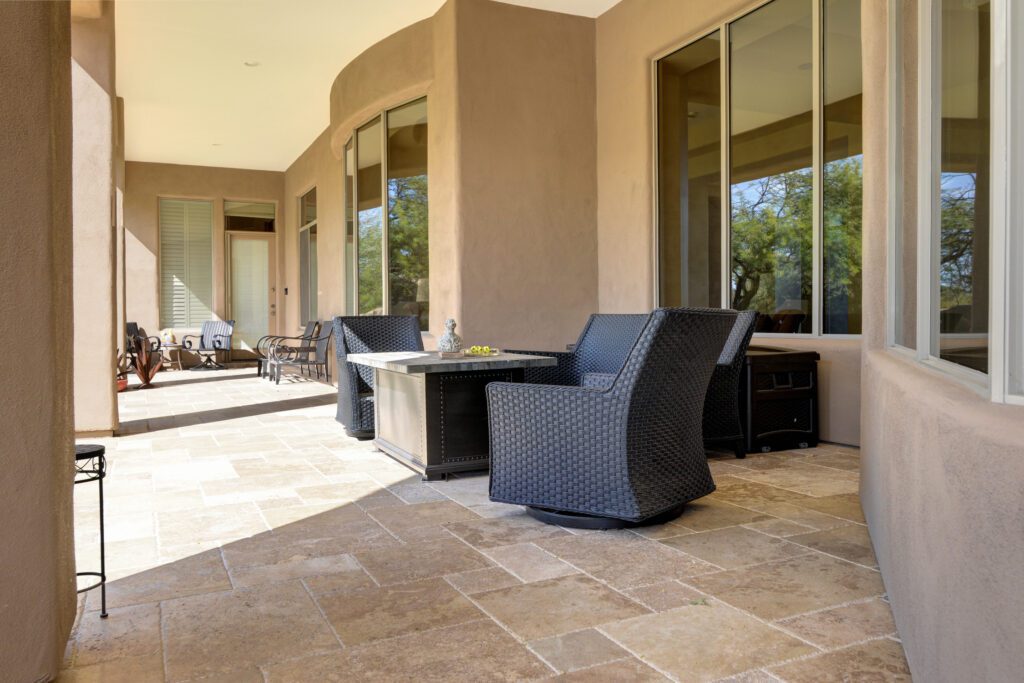 A patio with two chairs and a table