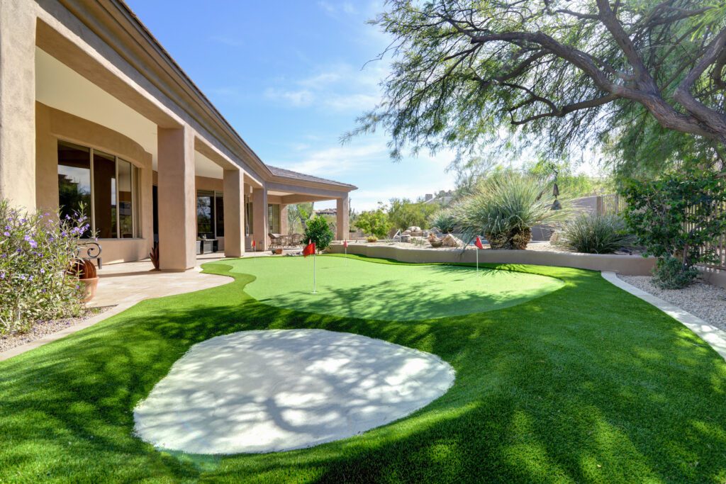 A large backyard with a golf course and trees.