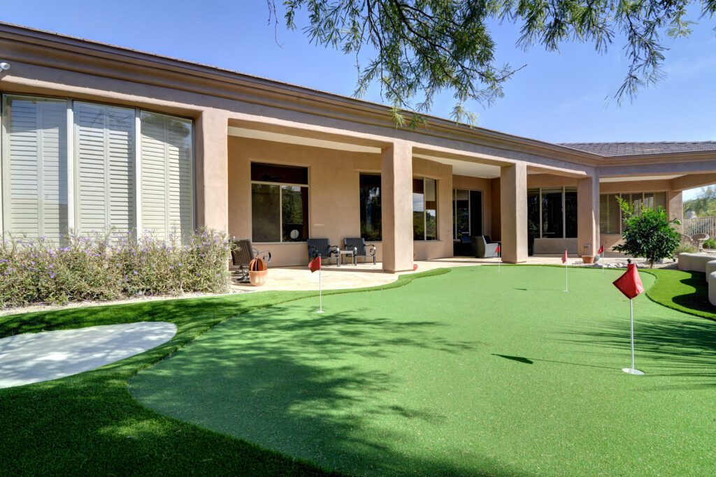 A large house with a lawn in the middle of it
