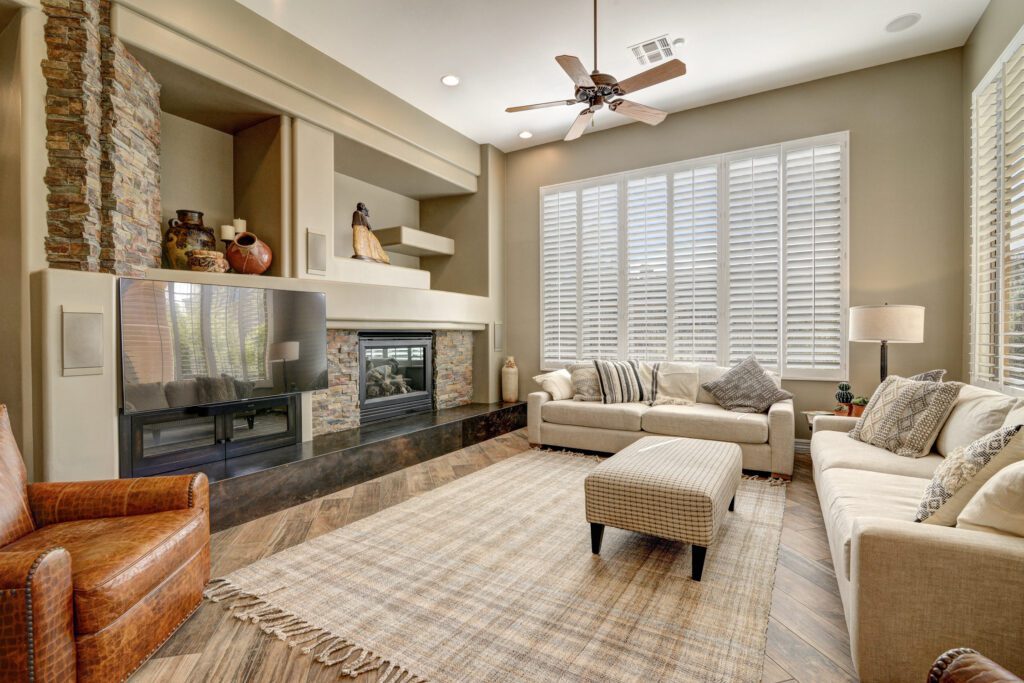 A living room with a fireplace and a large window.