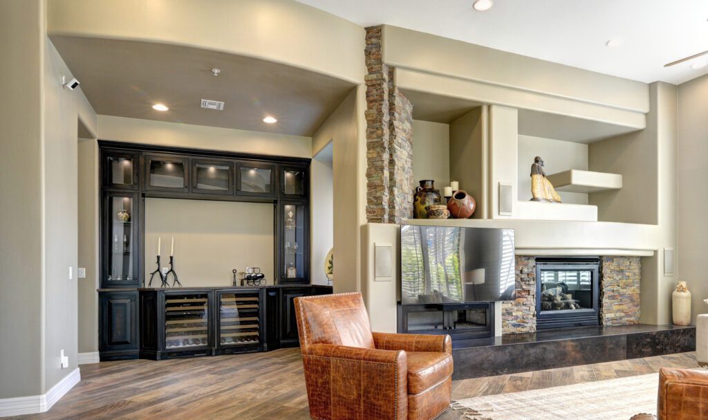 A living room with a fireplace and a leather chair.