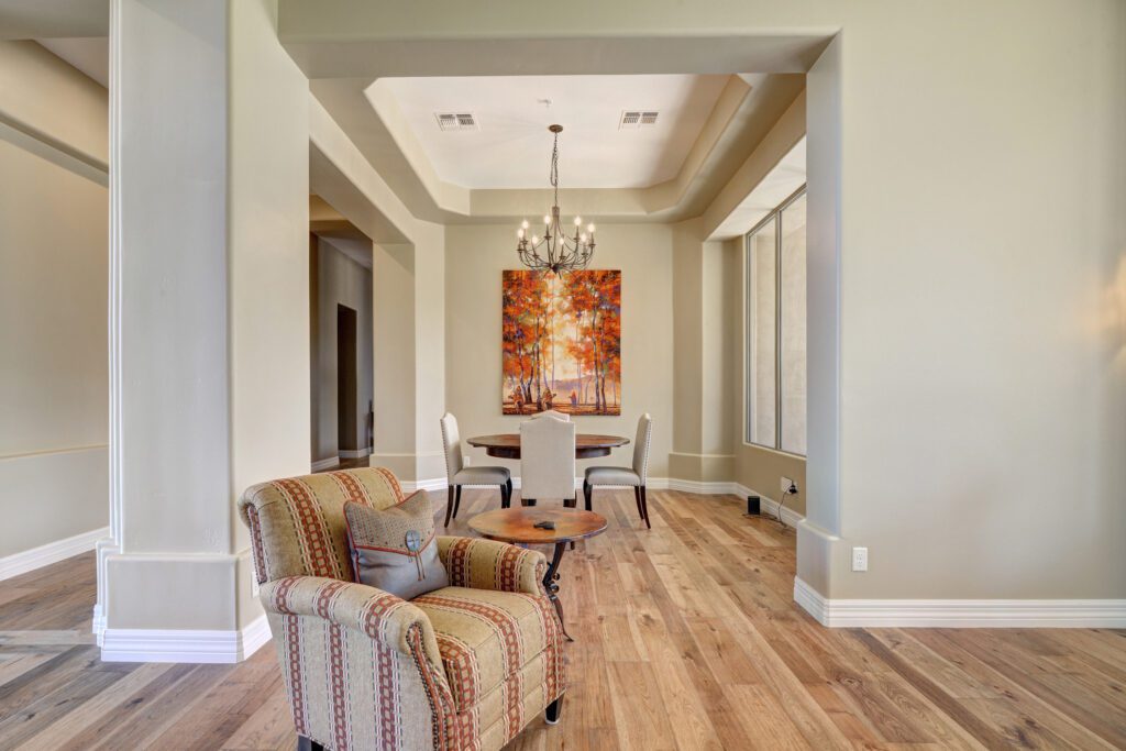 A living room with chairs and a table in it