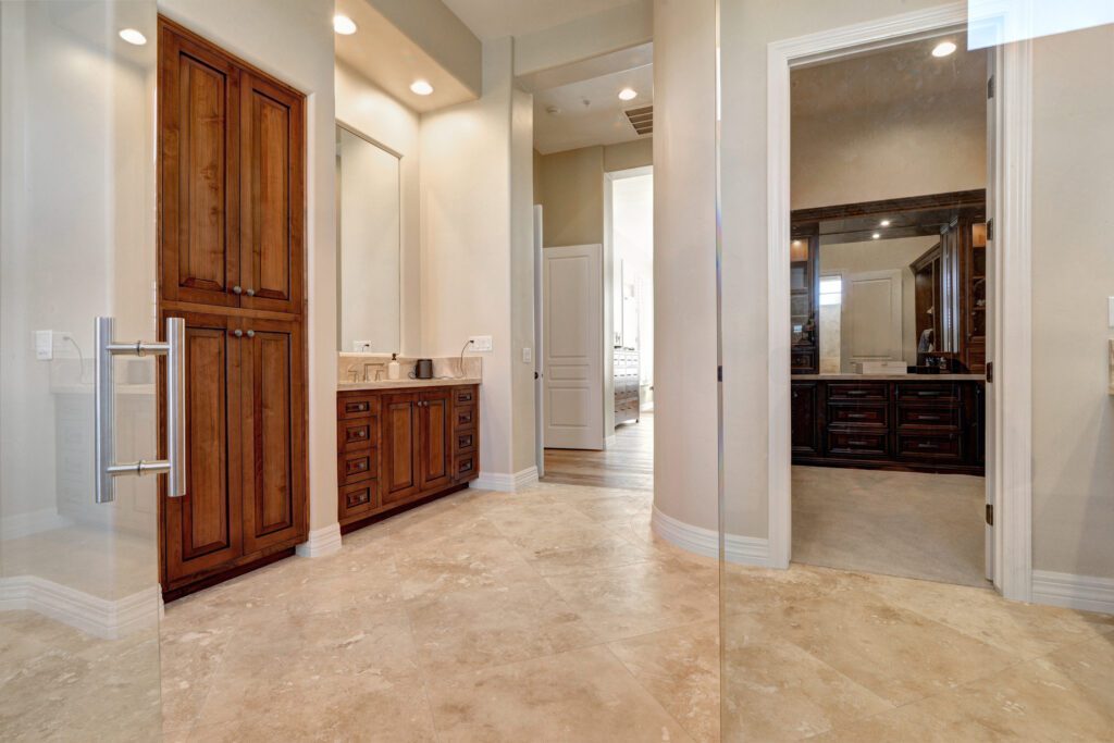 A bathroom with two sinks and a walk in shower.