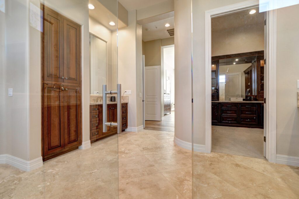 A bathroom with a walk in shower and a large mirror.
