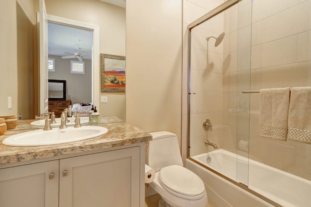 A bathroom with a toilet, sink and bathtub.