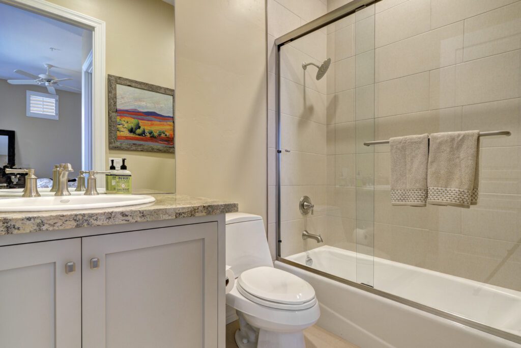 A bathroom with a toilet, sink and tub.