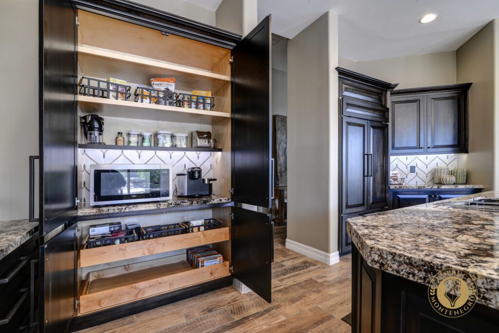 A kitchen with an open cabinet door and a counter.