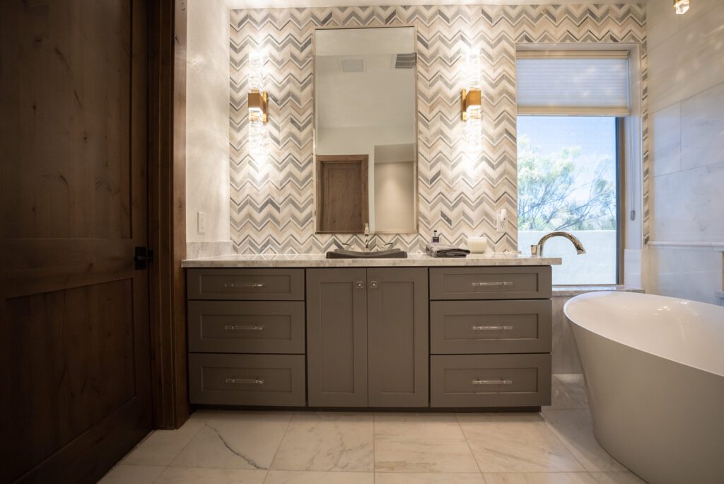 A bathroom with a large mirror and a sink.