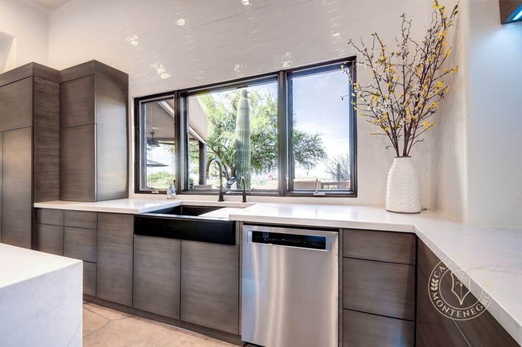 A kitchen with a sink and dishwasher in it
