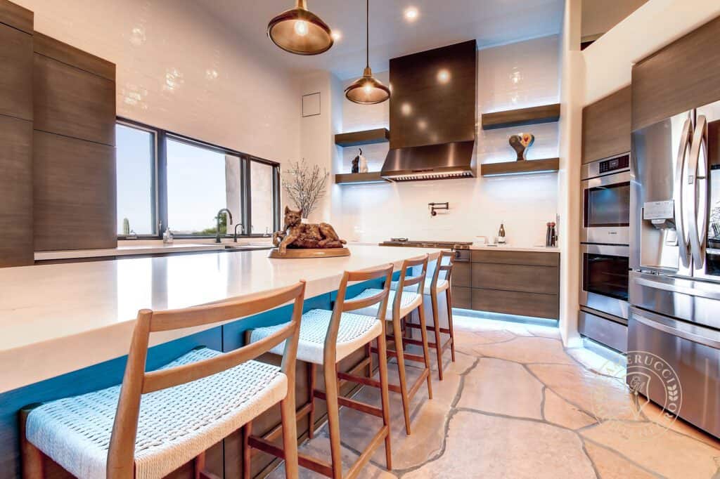 A kitchen with a table and chairs in it