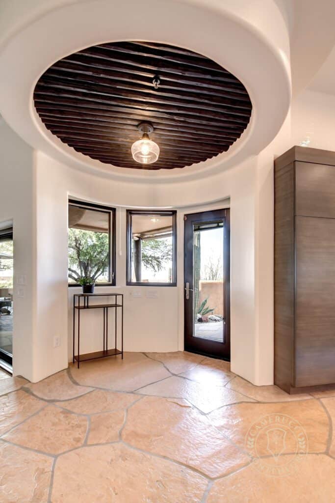 A room with a large window and a round ceiling.
