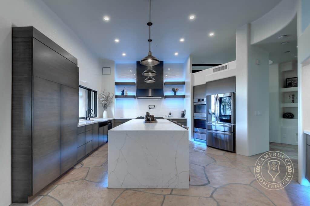 A large kitchen with a big island and lots of counter space.