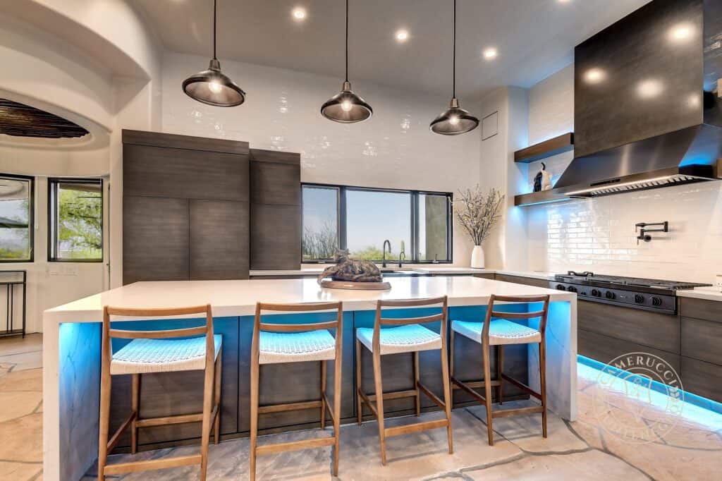 A kitchen with an island and bar stools.