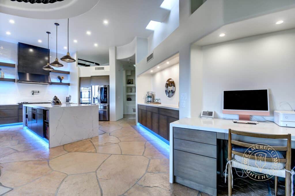 A kitchen with a large island and a dining table.